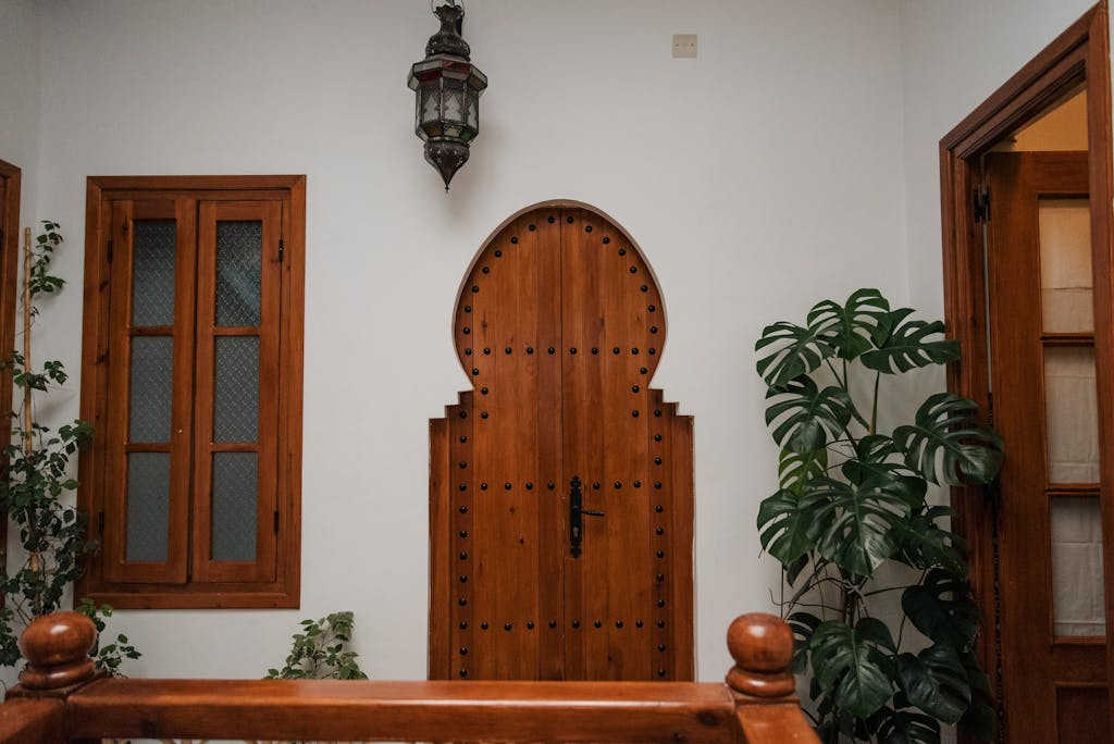 Cozy Moroccan interior featuring a distinct wooden door and lush plants.